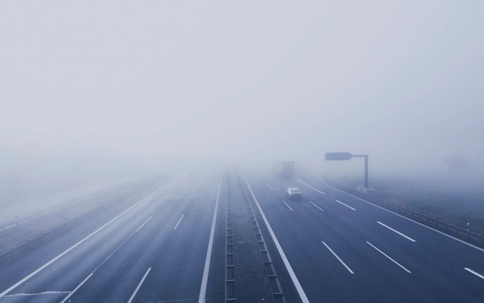 A motorway disappearing into fog
