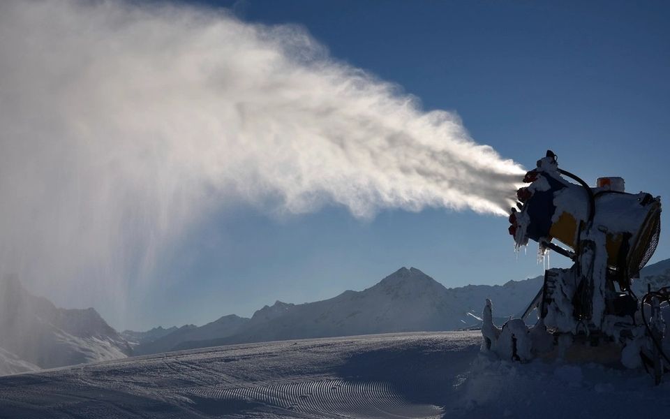 A snow cannon at work on a ski slope
